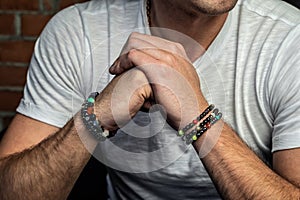 Jewelry bracelets on hand, made of natural stones and minerals, handmade. Arms crossed photo