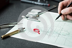 Jewelry designer works on a hand drawing sketc photo