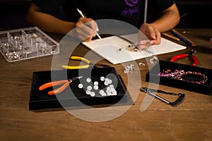 Jewelry designer works on a hand drawing sketch