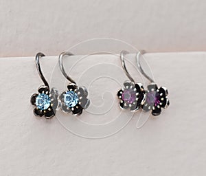 jewelry earrings with blue and purple stones on white background