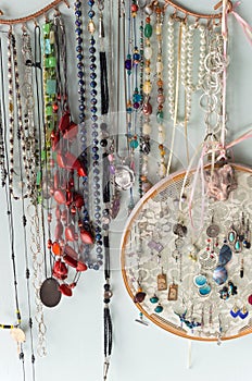 Jewelry and Finery Hanging Against Wall