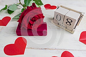 Jewelry gift box with  and bautiful red roses on wooden background. Greeting card for the 8th of March