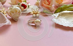 Jewelry gold  white pearl in seashell  Luxury Glamour fashion  costume jewelry ,roses  flowers petal  on blue and pink coral backg