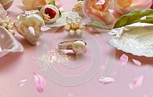 Jewelry gold  white pearl in seashell  Luxury Glamour fashion  costume jewelry ,roses  flowers petal  on blue and pink coral backg