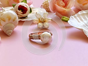 Jewelry gold  white pearl in seashell  Luxury Glamour fashion  costume jewelry ,roses  flowers petal  on blue and pink coral backg