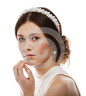 jewelry, luxury, wedding and people concept: young bride with gorgeous diadem in her hair isolated on white background