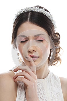 jewelry, luxury, wedding and people concept: young bride with gorgeous diadem in her hair isolated on white background