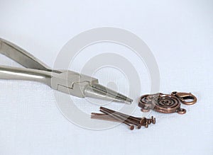 Jewelry Making Supplies on White Background - Pilrs, Pins, Connectors. Handmade Craft Concept