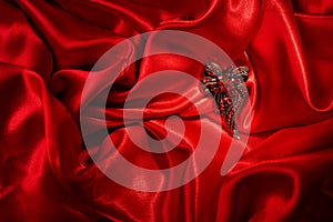 Jewelry over red silk background. Gem brooch.,