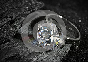 Jewelry ring with big diamond, on black coal background