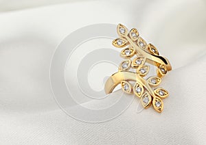 Jewelry ring with diamonds on white cloth, soft focus