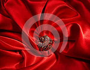 Jewelry ring over red silk background