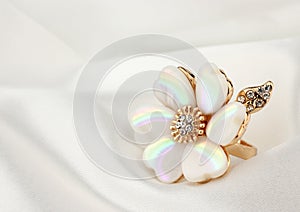 Jewelry ring with pearl on white cloth, soft focus