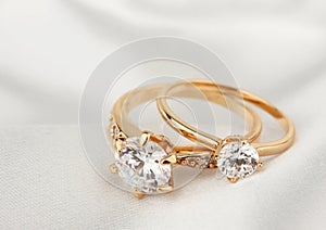Jewelry rings with diamond on white cloth, soft focus