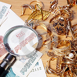 Jewelry scrap of gold and silver and money, pawnshop concept, closeup