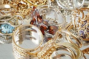 jewelry scrap of gold and silver and money, pawnshop concept jeweler looking at jewelry through magnifying glass, jewerly