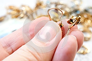 jewelry scrap of gold and silver and money, pawnshop concept jeweler looking at jewelry through magnifying glass, jewerly