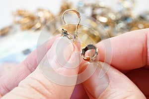 jewelry scrap of gold and silver and money, pawnshop concept jeweler looking at jewelry through magnifying glass, jewerly