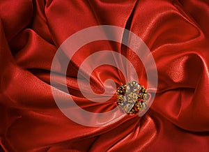 Jewelry Shape over Red Silk Cloth Background, Fabric folds