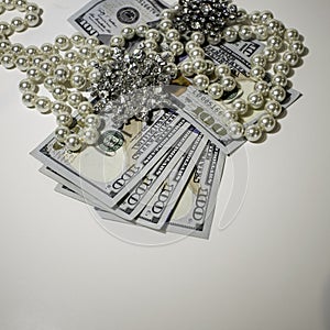Jewelry on Top of Hundred Dollar Bills