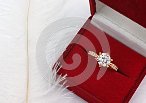 Jewelry wedding ring with diamond in gift box on white