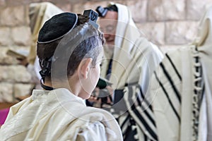 Jewish bar mitzvah , praying in a synagogue with tallit