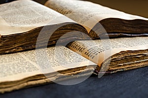 Jewish Bible. An open old Jewish books. Opened scripture pages. Selective focus. Closeup of hebrew text