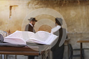 Jewish bible on table, wailing western wall, jerusalem, israel. book of the Torah-the Pentateuch of Moses is open on the prayer