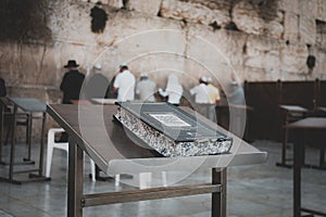 Jewish bible on table, wailing western wall, jerusalem, israel. book of the Torah-the Pentateuch of Moses on the prayer table on photo