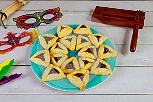 Jewish cookies Haman ears for Purim with mask and noisemaker