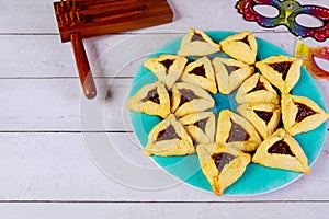 Jewish cookies Haman ears for Purim with mask and noisemaker