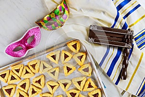 Jewish cookies for Purim with mask, tallit and noisemaker