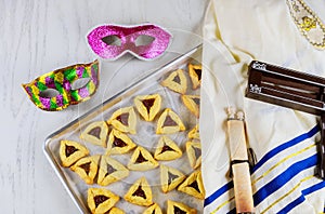 Jewish cookies for Purim with mask, tallit and noisemaker