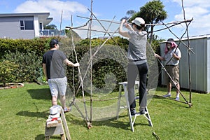 Jewish Family Building a Sukkah on Sukkoth Feast of Tabernacles photo