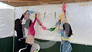 Jewish family decorating the interior of a Sukkah