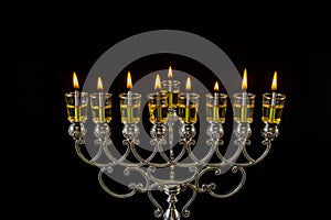 Jewish festival of lights holiday symbol Chanukkah menorah in hanukkiah on oil candles