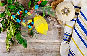 Jewish festival of sukkoth over paper colorful chain garland on kippah photo