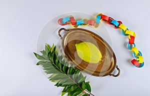 Jewish festival of sukkoth over paper colorful chain garland on kippah photo