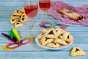 Jewish hamantashen cookies, mask, wine and megillah papyrus roll photo