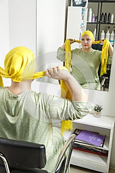 A Jewish Hasidic woman from the Orthodox community who shaved her head after her wedding in front of a mirror in a