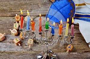 Jewish holiday hannukah symbols - menorah, doughnuts, chockolate coins and wooden dreidels.