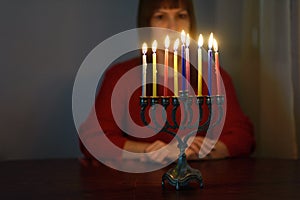 Jewish holiday Hanukkah background with menorah and colorful burning candles.