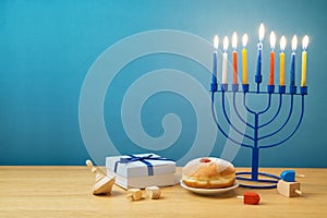 Jewish holiday Hanukkah background with menorah, sufganiyot, gif