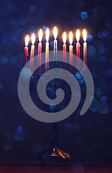 jewish holiday Hanukkah background with menorah & x28;traditional candelabra& x29; and burning candles.
