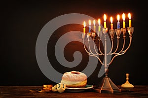 jewish holiday Hanukkah background with traditional spinnig top, menorah & x28;traditional candelabra& x29; and burning candles