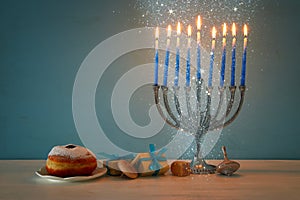 jewish holiday Hanukkah background with traditional spinnig top, menorah & x28;traditional candelabra& x29; and burning candles