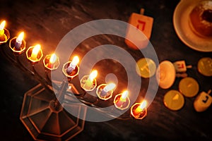 jewish holiday Hanukkah background with traditional spinnig top, menorah & x28;traditional candelabra& x29; and burning candles