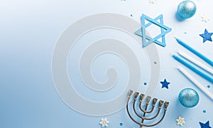 Jewish holiday Hanukkah concept. Top view of menorah and candles on blue background