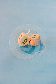 Jewish holiday Hanukkah concept. Wooden dreidel spinning top