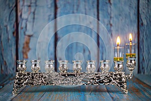 jewish holiday Hanukkah with lighting the first candle on a hanukkah menorah traditional candelabra